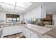 Bright kitchen with white cabinets, tile countertops and view of the living room at 2118 Wells Av, Sarasota, FL 34232