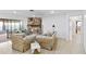 Cozy living room featuring tile floors, stone fireplace, comfortable furniture, and natural light at 2118 Wells Av, Sarasota, FL 34232