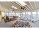 Bright sunroom with skylights, ceiling fans, a seating area, and a dining table at 2118 Wells Av, Sarasota, FL 34232