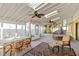 Bright sunroom with a dining table, chairs, a bed, skylights, and ceiling fans at 2118 Wells Av, Sarasota, FL 34232