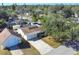 Aerial view of a nicely landscaped home with mature trees, a garage, and close proximity to nearby amenities at 2202 21St W St, Bradenton, FL 34205