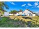 Expansive backyard with a deck, table, and various equipment, under a clear blue sky at 2202 21St W St, Bradenton, FL 34205