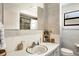 A bathroom with a sink, mirror, and toilet, complemented by decor and a window for natural light at 2202 21St W St, Bradenton, FL 34205