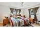 Cozy bedroom featuring a vibrant striped quilt, two windows, and two matching nightstands at 2202 21St W St, Bradenton, FL 34205