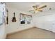 This bedroom features tile floors, a ceiling fan, a window with curtains, and a closet at 2202 21St W St, Bradenton, FL 34205