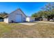 Spacious exterior showcasing garage, an oversized driveway, green lawn and mature trees on a sunny day at 2202 21St W St, Bradenton, FL 34205