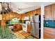 Functional kitchen with stainless steel refrigerator, wooden cabinets and tile countertops at 2202 21St W St, Bradenton, FL 34205