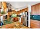 Traditional kitchen featuring wood cabinets, green tile countertops, and a stainless steel refrigerator at 2202 21St W St, Bradenton, FL 34205