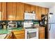 Charming kitchen with green tiled backsplash and countertops, complete with modern appliances at 2202 21St W St, Bradenton, FL 34205