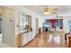 Bright living room featuring hardwood floors, a decorative cabinet, and views into other rooms at 2202 21St W St, Bradenton, FL 34205