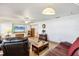 Comfortable living room with tile floors, ceiling fan and a mounted flatscreen television at 2202 21St W St, Bradenton, FL 34205