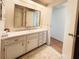 Bathroom vanity featuring a large mirror, drawers, and cabinet space for storage at 3236 Sumac Ter, Sarasota, FL 34237