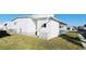 Exterior side view of home with a white siding, green grass and street view at 3236 Sumac Ter, Sarasota, FL 34237