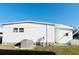 Exterior side view of home with new AC unit and white horizontal siding, surrounded by green grass at 3236 Sumac Ter, Sarasota, FL 34237