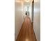 Long hallway with wood flooring connecting the living spaces in the home at 3236 Sumac Ter, Sarasota, FL 34237