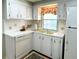 Well-lit kitchen with a window over the sink and white appliances, creating a cheerful space at 3236 Sumac Ter, Sarasota, FL 34237