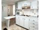 White kitchen offers ample storage, counter space, and a convenient breakfast bar at 3236 Sumac Ter, Sarasota, FL 34237