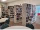 Cozy community library featuring bookshelves filled with various books, tables, and chairs at 3236 Sumac Ter, Sarasota, FL 34237