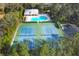 Aerial view showcasing the community pool and tennis courts at 3301 River Woods Dr, Parrish, FL 34219