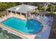 Aerial view of community pool with covered seating and lounge chairs, perfect for relaxation and recreation at 3301 River Woods Dr, Parrish, FL 34219