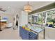 Bright dining nook with a modern glass table and views of the screened-in lanai at 3301 River Woods Dr, Parrish, FL 34219