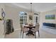 Cozy dining room with an elegant chandelier, hardwood table set, and views of the outdoors at 3301 River Woods Dr, Parrish, FL 34219