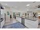 Open kitchen with granite counters, stainless appliances, and modern cabinets leading into the living room at 3301 River Woods Dr, Parrish, FL 34219