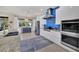 Contemporary kitchen with a stainless steel hood, white cabinets, a patterned rug, and a view to the outside at 3301 River Woods Dr, Parrish, FL 34219