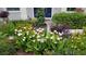 Lush front yard landscaping with a variety of plants and flowers at 3301 River Woods Dr, Parrish, FL 34219