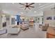 Spacious living room featuring tile floors, modern furniture, and an open floor plan leading to the kitchen at 3301 River Woods Dr, Parrish, FL 34219