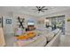 Bright living room with tray ceiling, fan, modern furnishings, and sliding glass doors to an outdoor living space at 3301 River Woods Dr, Parrish, FL 34219