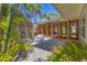 Tranquil backyard space with gravel, a small white table, and lush greenery providing a peaceful outdoor area at 344 Monroe Dr, Sarasota, FL 34236