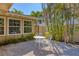 Charming backyard area with gravel landscaping, a small white table, and tropical foliage creating a serene retreat at 344 Monroe Dr, Sarasota, FL 34236