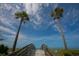 Inviting beach access with palm trees, blue skies, and views of the ocean at 344 Monroe Dr, Sarasota, FL 34236