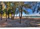 Picturesque beach featuring tall pine trees, picnic benches, and tranquil bay views at 344 Monroe Dr, Sarasota, FL 34236