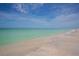 Picturesque beach featuring white sand, blue ocean, and a clear, sunny sky at 344 Monroe Dr, Sarasota, FL 34236