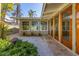 Back exterior of home featuring warm colors, a garden, and walkway featuring access to the interior of the house at 344 Monroe Dr, Sarasota, FL 34236