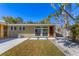 Exterior home shot featuring tidy yard, modern windows, and a light tan color scheme at 344 Monroe Dr, Sarasota, FL 34236