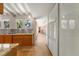 Hallway featuring travertine floor and leading to kitchen with modern stainless steel appliances at 344 Monroe Dr, Sarasota, FL 34236