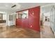 Open layout featuring travertine flooring, a partial red wall, and modern lighting fixture at 344 Monroe Dr, Sarasota, FL 34236