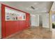 Bright room with travertine floor, a partial accent wall, and modern lighting fixture at 344 Monroe Dr, Sarasota, FL 34236