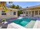 A lovely swimming pool between the home and a cabana and featuring tiled decking and room to relax at 344 Monroe Dr, Sarasota, FL 34236