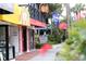 Charming storefronts with colorful awnings and signage line a quaint street in a vibrant downtown area at 344 Monroe Dr, Sarasota, FL 34236