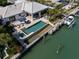 Stunning aerial view showcasing the property's waterfront location with pool, patio, and private boat dock at 355 W Royal Flamingo Dr, Sarasota, FL 34236