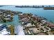 Gorgeous aerial view of waterfront home featuring a private dock, pool, and lush landscaping at 355 W Royal Flamingo Dr, Sarasota, FL 34236