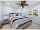 Comfortable bedroom with a ceiling fan, plantation shutters, and a cozy bed with blue accents at 355 W Royal Flamingo Dr, Sarasota, FL 34236