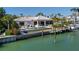 Exterior side view of house with pool, dock, and covered outdoor seating area and entertaining space at 355 W Royal Flamingo Dr, Sarasota, FL 34236