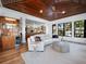 Open-concept living room features a vaulted wood ceiling, neutral color palette, and access to the kitchen at 355 W Royal Flamingo Dr, Sarasota, FL 34236