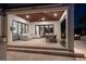 Covered outdoor living space with travertine tile, wood ceiling, and a dining table with seating at 355 W Royal Flamingo Dr, Sarasota, FL 34236