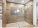 Modern shower room featuring glass door, rain shower head, pebble floor and unique tile design at 355 W Royal Flamingo Dr, Sarasota, FL 34236